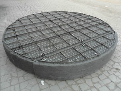 A piece of dour-part demister pad with crimped wire mesh and flat bar supporting grid on the ground.