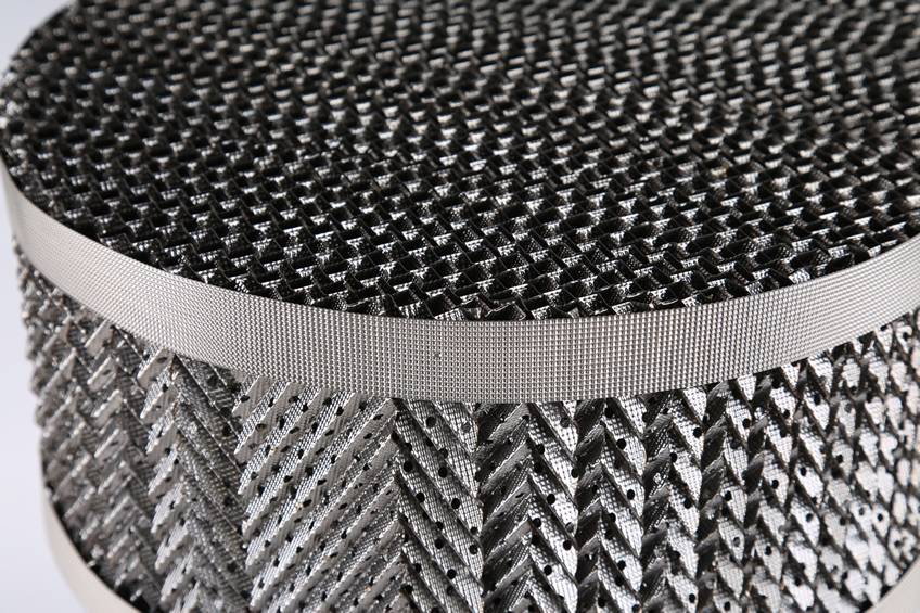 A detail of perforated plate structured packing on gray background.
