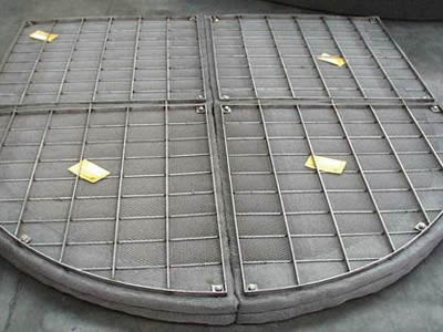 A four-part special shape demister pad on the ground.