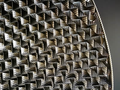Metal perforated plate corrugated packing from front side.