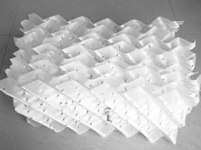 A plastic perforated plate packing on the gray background.